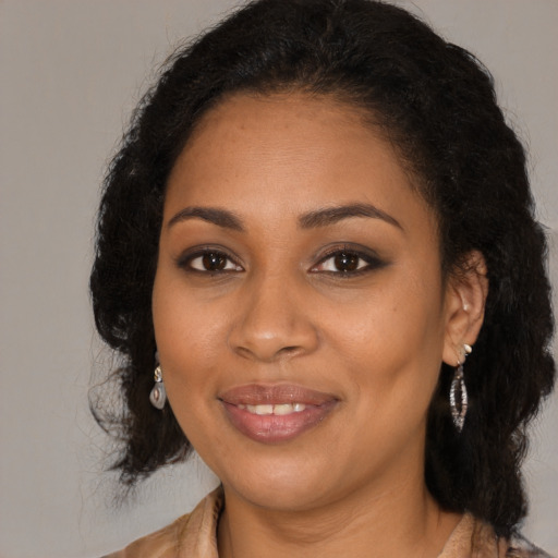 Joyful black young-adult female with long  brown hair and brown eyes