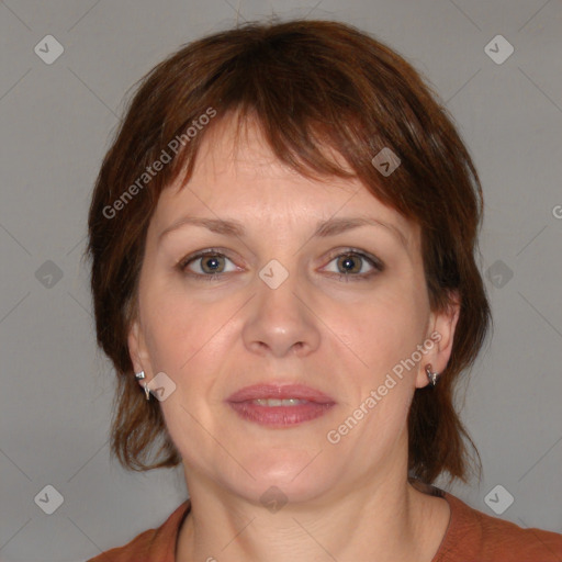 Joyful white adult female with medium  brown hair and blue eyes