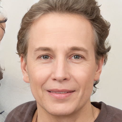 Joyful white adult male with medium  brown hair and grey eyes