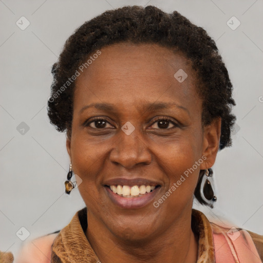 Joyful black adult female with short  brown hair and brown eyes