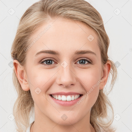 Joyful white young-adult female with medium  brown hair and blue eyes