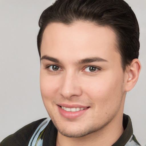 Joyful white young-adult male with short  brown hair and brown eyes