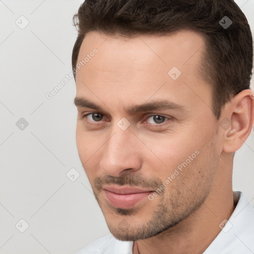 Joyful white young-adult male with short  brown hair and brown eyes