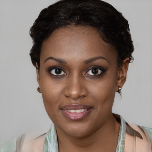 Joyful black young-adult female with short  brown hair and brown eyes