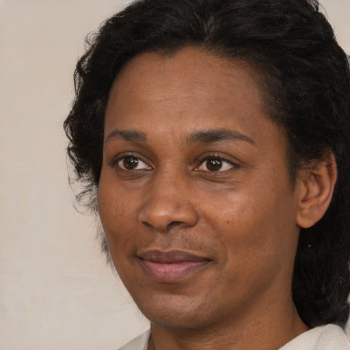 Joyful black adult female with short  brown hair and brown eyes