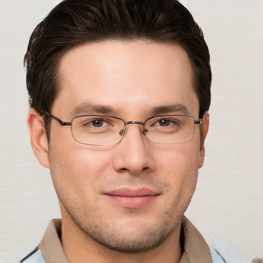 Joyful white young-adult male with short  brown hair and grey eyes