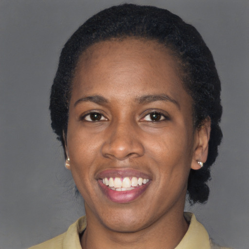 Joyful black adult female with short  brown hair and brown eyes