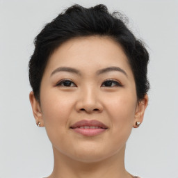 Joyful asian young-adult female with short  brown hair and brown eyes