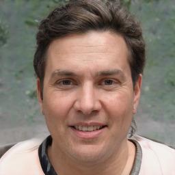 Joyful white adult male with short  brown hair and brown eyes