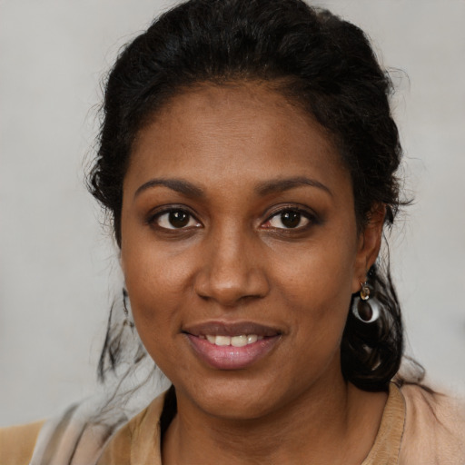 Joyful black young-adult female with medium  brown hair and brown eyes
