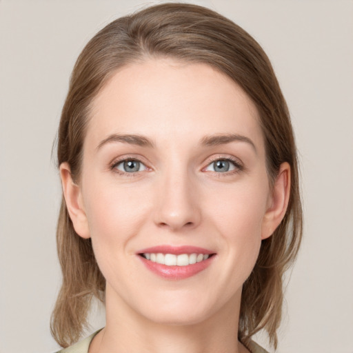 Joyful white young-adult female with medium  brown hair and grey eyes