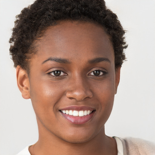 Joyful black young-adult female with short  brown hair and brown eyes