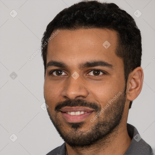 Joyful black young-adult male with short  black hair and brown eyes