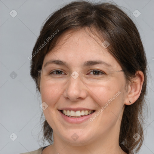 Joyful white adult female with medium  brown hair and brown eyes