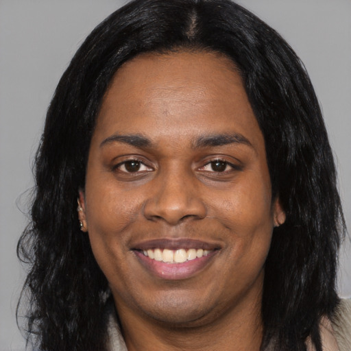 Joyful black young-adult female with long  black hair and brown eyes