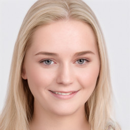 Joyful white young-adult female with long  brown hair and blue eyes