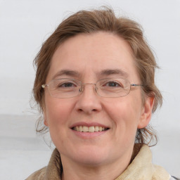 Joyful white adult female with medium  brown hair and blue eyes