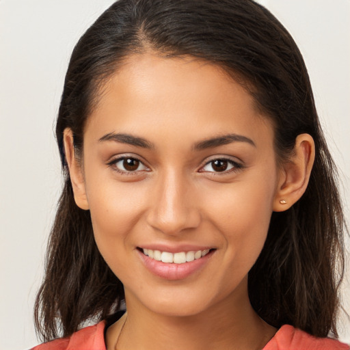 Joyful white young-adult female with long  brown hair and brown eyes