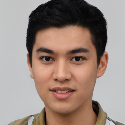 Joyful asian young-adult male with short  black hair and brown eyes