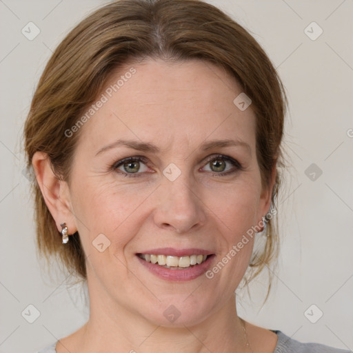 Joyful white adult female with medium  brown hair and grey eyes