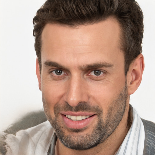 Joyful white adult male with short  brown hair and brown eyes