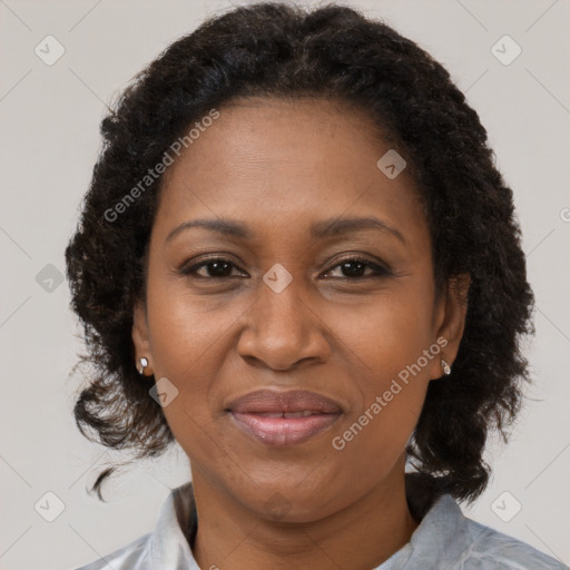 Joyful black adult female with medium  brown hair and brown eyes