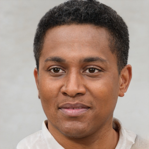 Joyful latino young-adult male with short  brown hair and brown eyes