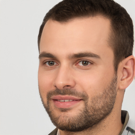 Joyful white young-adult male with short  brown hair and brown eyes