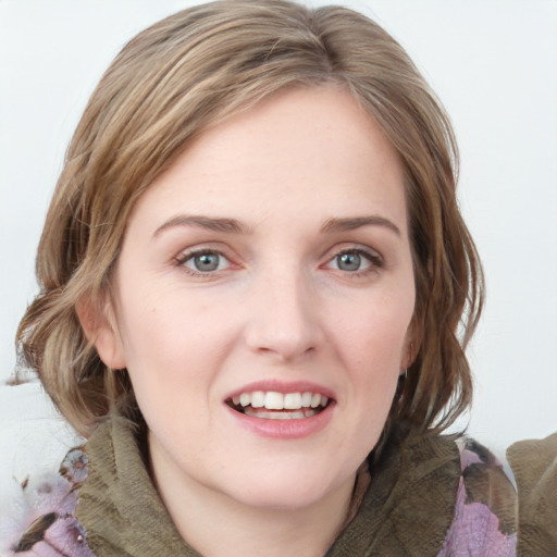 Joyful white young-adult female with medium  brown hair and blue eyes