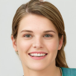 Joyful white young-adult female with medium  brown hair and green eyes