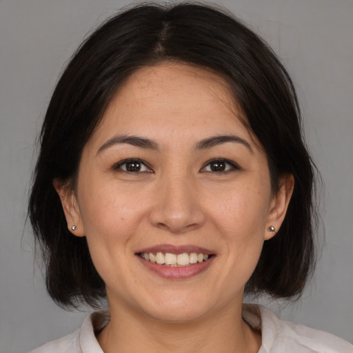 Joyful white young-adult female with medium  brown hair and brown eyes