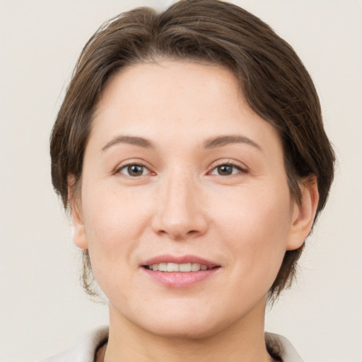 Joyful white young-adult female with medium  brown hair and brown eyes