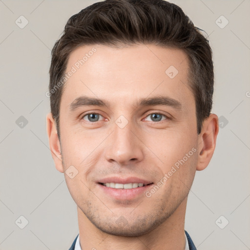 Joyful white young-adult male with short  brown hair and brown eyes