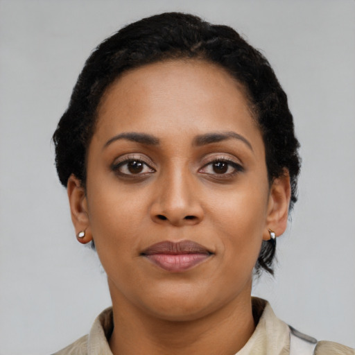 Joyful latino young-adult female with short  black hair and brown eyes
