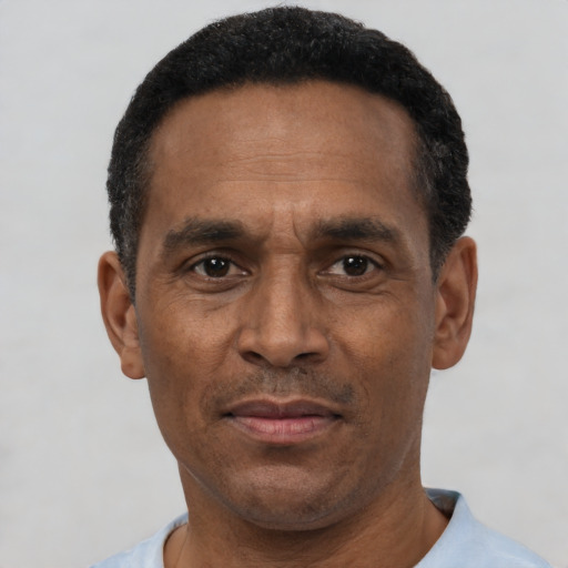 Joyful latino adult male with short  black hair and brown eyes