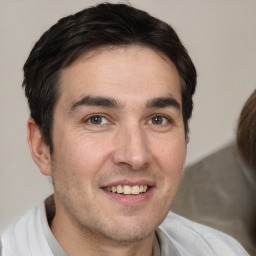 Joyful white adult male with short  brown hair and brown eyes