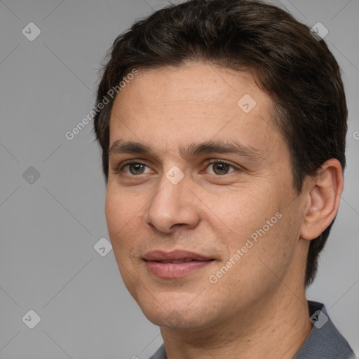 Joyful white adult male with short  brown hair and brown eyes