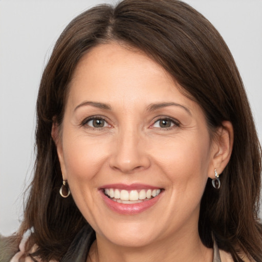 Joyful white adult female with medium  brown hair and brown eyes