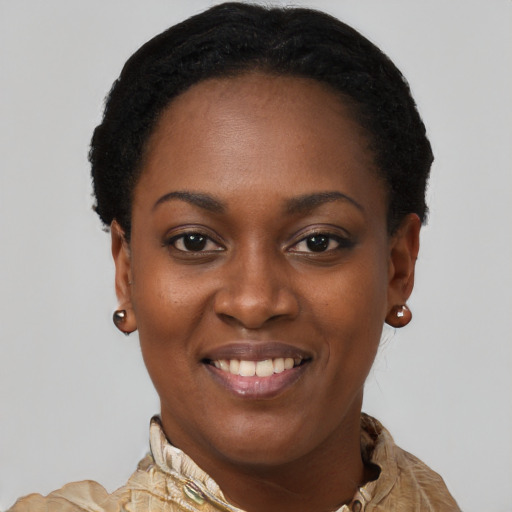 Joyful black young-adult female with short  black hair and brown eyes