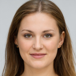 Joyful white young-adult female with long  brown hair and green eyes