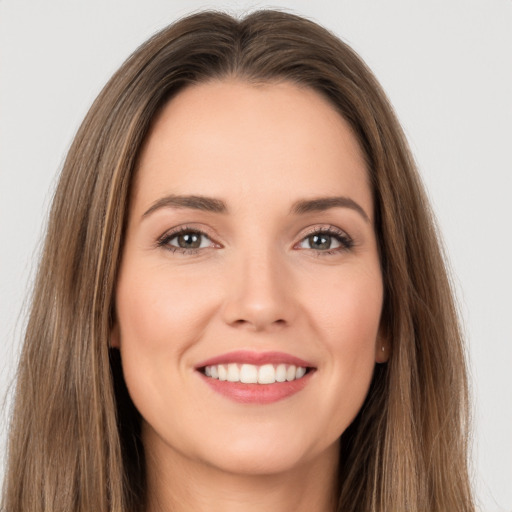 Joyful white young-adult female with long  brown hair and brown eyes