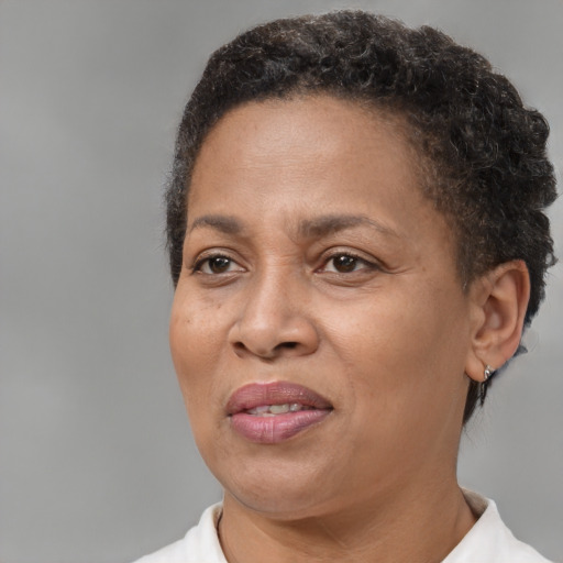 Joyful black adult female with short  brown hair and brown eyes