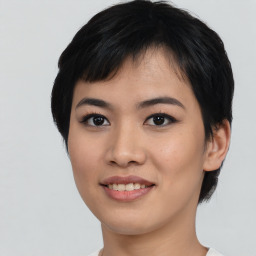 Joyful asian young-adult female with medium  black hair and brown eyes