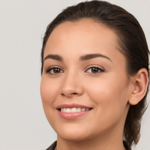 Joyful white young-adult female with long  brown hair and brown eyes