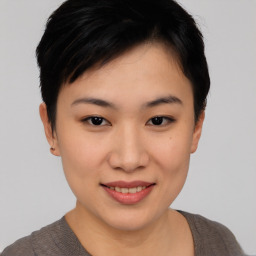 Joyful asian young-adult female with short  black hair and brown eyes