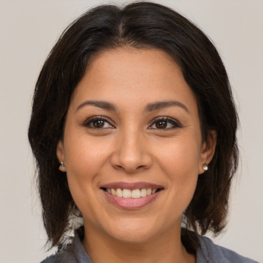 Joyful white young-adult female with medium  brown hair and brown eyes