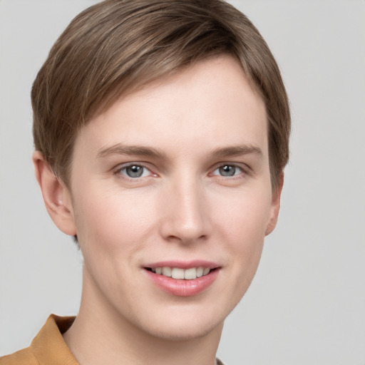 Joyful white young-adult female with short  brown hair and grey eyes