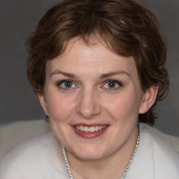 Joyful white young-adult female with medium  brown hair and blue eyes