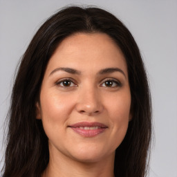 Joyful white young-adult female with long  brown hair and brown eyes