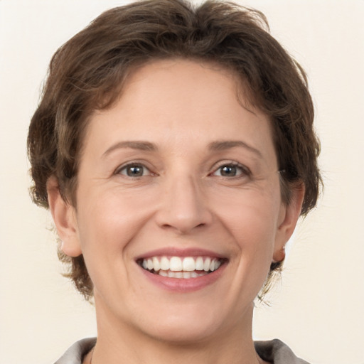 Joyful white adult female with short  brown hair and brown eyes